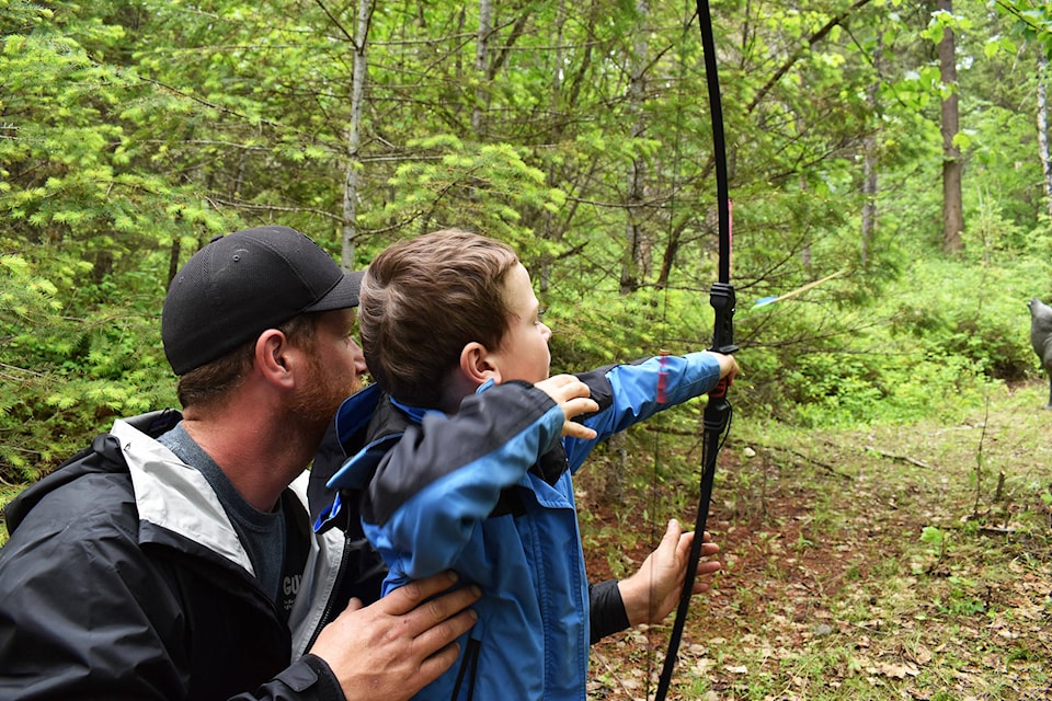 James Boe and son Jaxon let loose an arrow towards a target at the 3D Archery Shoot hosted by the Salmon Arm Fish and Game Club on Saturday, May 25. (Cameron Thomson/Salmon Arm Observer)