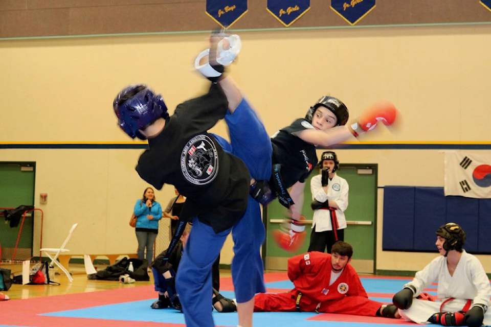 Houston Rampton and Damon Doiron of Salmon Arm spar in the gold-medal round in the junior boys black belt division on Saturday, May 25. (Submitted photo)