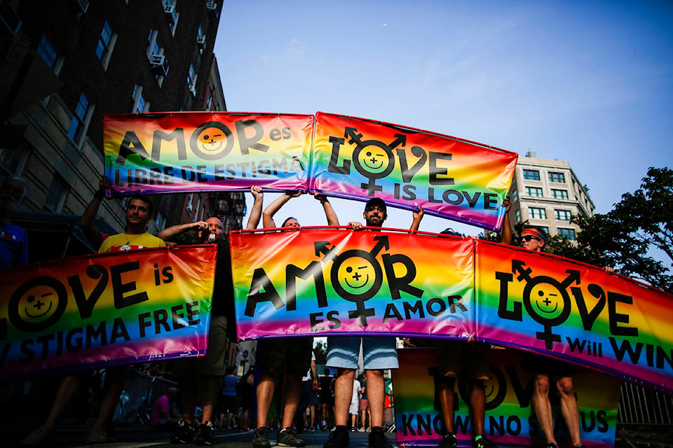 People arrive to attend the Stonewall 50 Pride Rally, Friday, June 28, 2019, in New York. (AP Photo/Eduardo Munoz Alvarez)