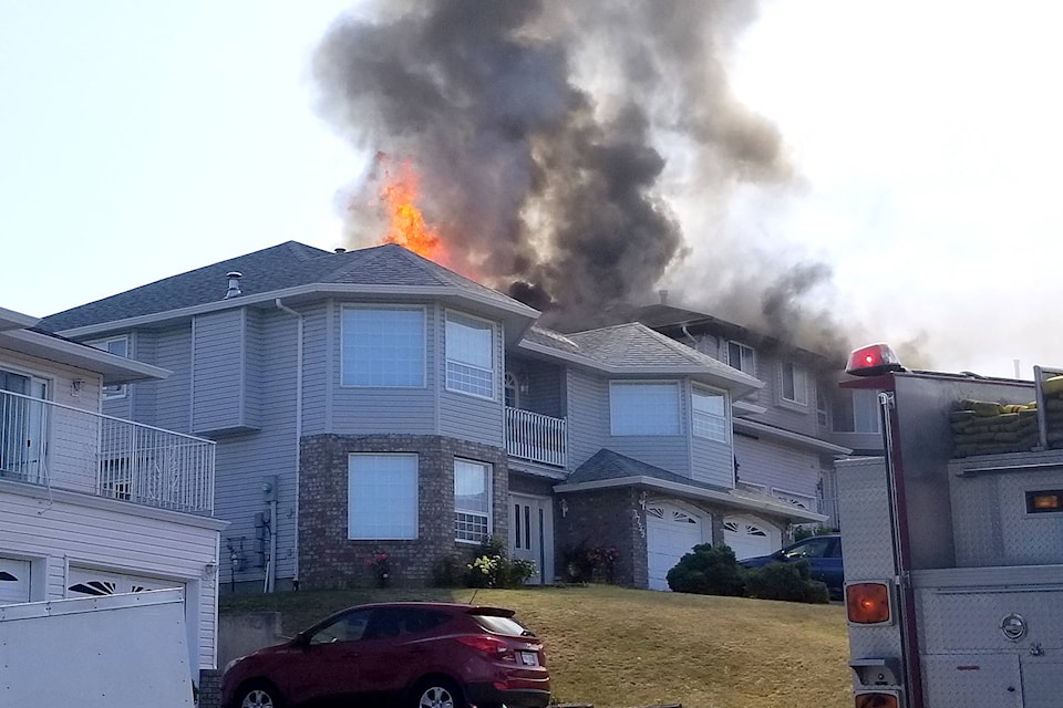 Firefighters converge at a house fire on Commonage Place Thursday afternoon. (Roger Knox - Morning Star)