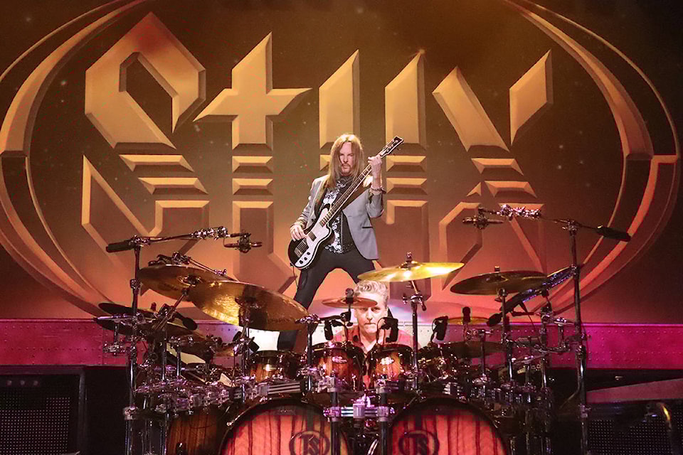 Bassist Ricky Phillips (top) and drummer Todd Sucherman of iconic American band Styx put the work into Blue Collar Man, one of 14 songs played by the legendary group over 90 minutes Wednesday before an enthusiastic, appreciative crowd at Penticton’s South Okanagan Events Centre. (Roger Knox - Black Press)