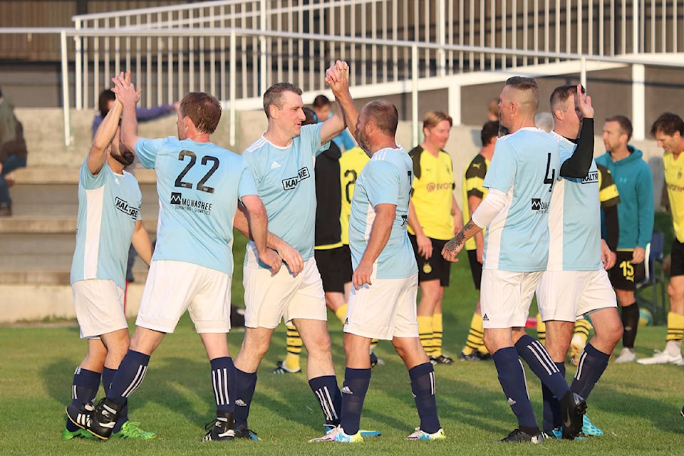 Vernon Kal Tire’s John Orton (left, centre) and Jason Beck celebrate with teammates after winning the CapriCMW Okanagan Oldtimer’s 45+ Soccer League’s A Division Championship Sunday, Oct. 6, with a 2-1 win over Kelowna Mission Cleaners at Lake Country’s Beasley Park. (Roger Knox - Black Press)