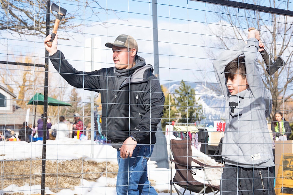 Kyle and Gavin Brown throw axes in the Cedar Axe Throwing booth as part of the fill the pantry February fundraiser held at the Shuswap Family Centre on Monday, Feb. 17. (Jim Elliot - Salmon Arm Observer)