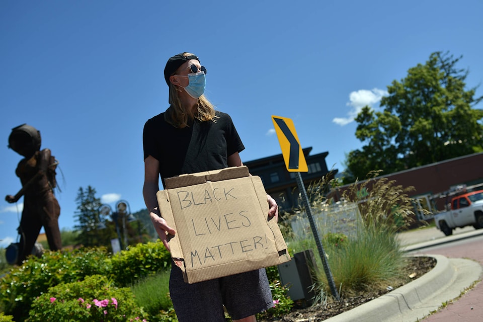 Geoff Stathers stands on the Front St. roundabout in Penticton June 3, holding a sign that reads, ‘Black Lives Matter!’ (Phil McLachlan - Western News)