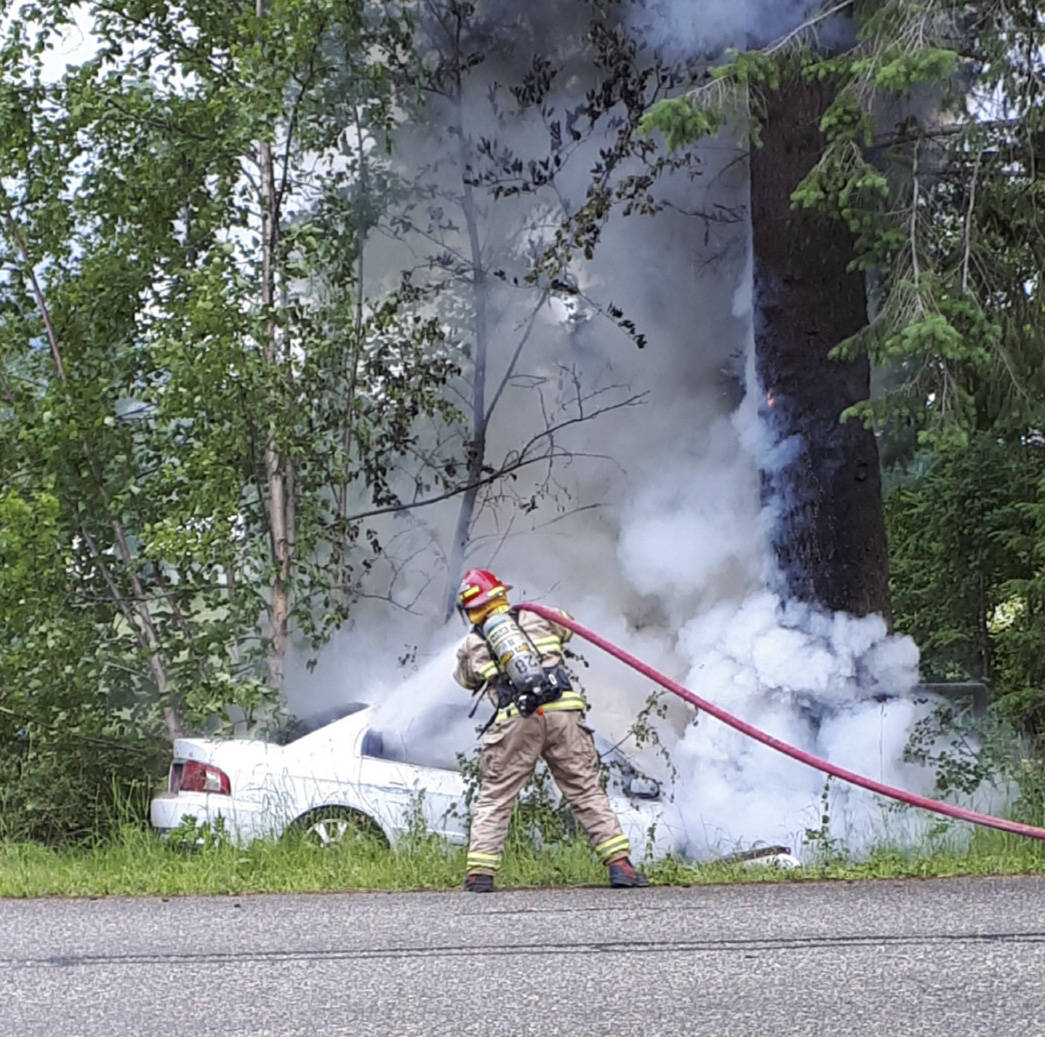 21960820_web1_200701-SAA-firefighter-douses-fire