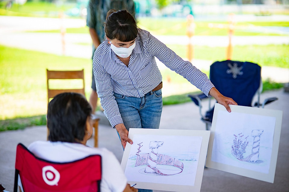 Coordinator of the Secwepemc Landmark and Trail Sign Project, Libby Jay Chisholm, holds the draft designs of Eric Kutschker, Rod Tomma and Tilkotmes Tomma. (Jacob Sutra Brett photo)