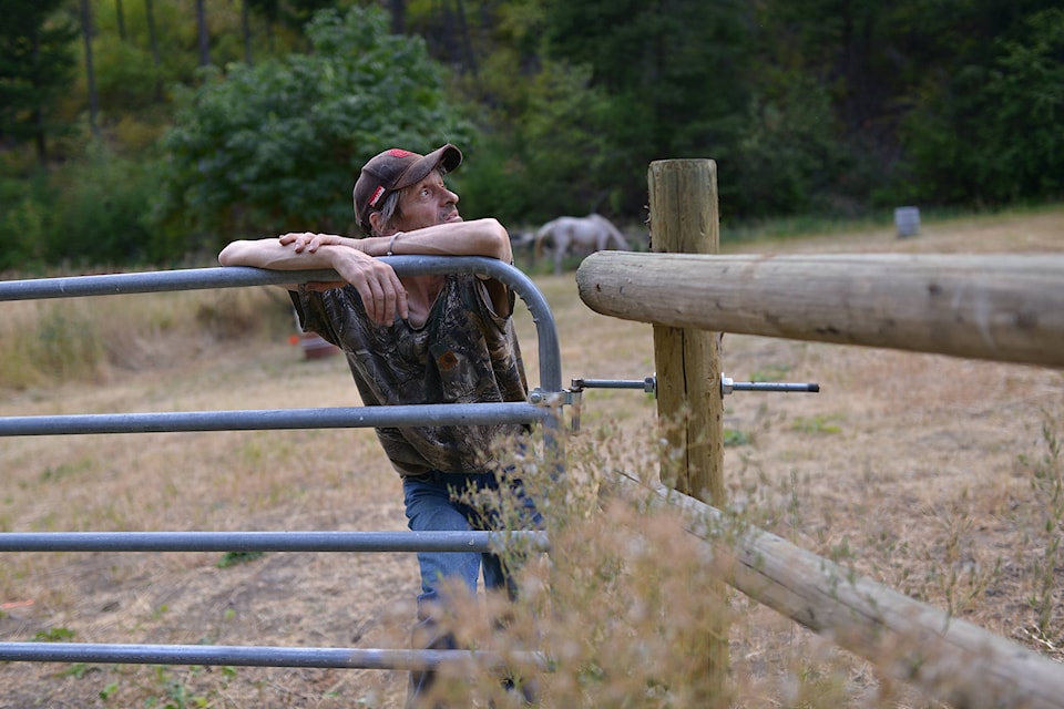 Pictured is Dennis Shelbey watching the fire from his pasture. (Phil McLachlan – Western News)