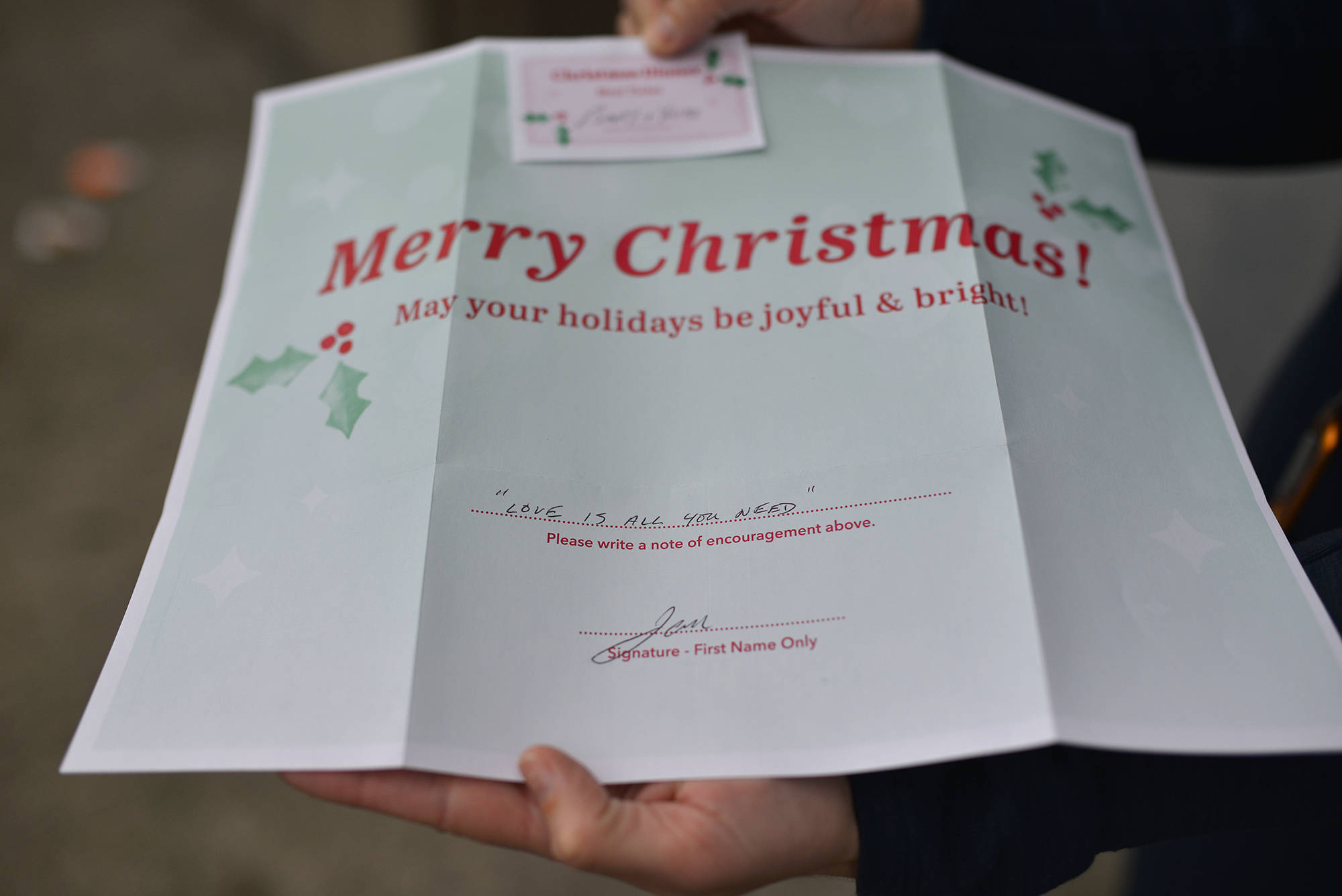 A place mat on a table inside the Gospel Mission has a message from a donor, which reads, Love is all you need. (Phil McLachlan - Capital News)