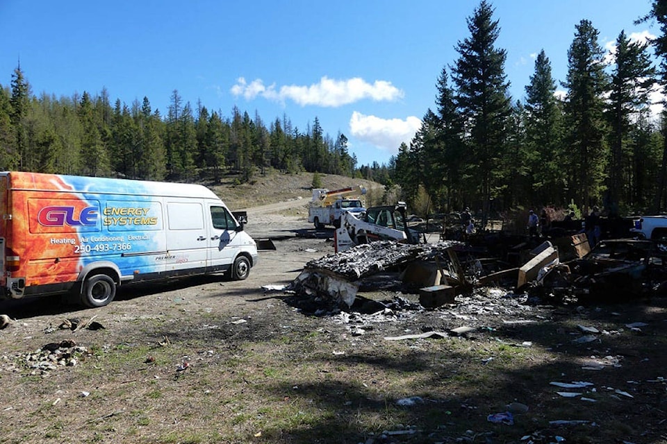 Several Penticton businesses got together to clean up a burned-out motorhome, trailer and more at Carmi rec trails parking lot. (Neda Joss photo)