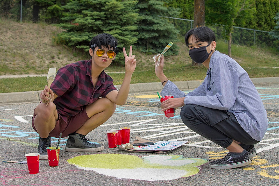 Johann Oriana and Neo Moren paint a Yoshi head on June 11 at Salmon Arm Secondary’s Sullivan campus. (Zachary Roman - Salmon Arm Observer)