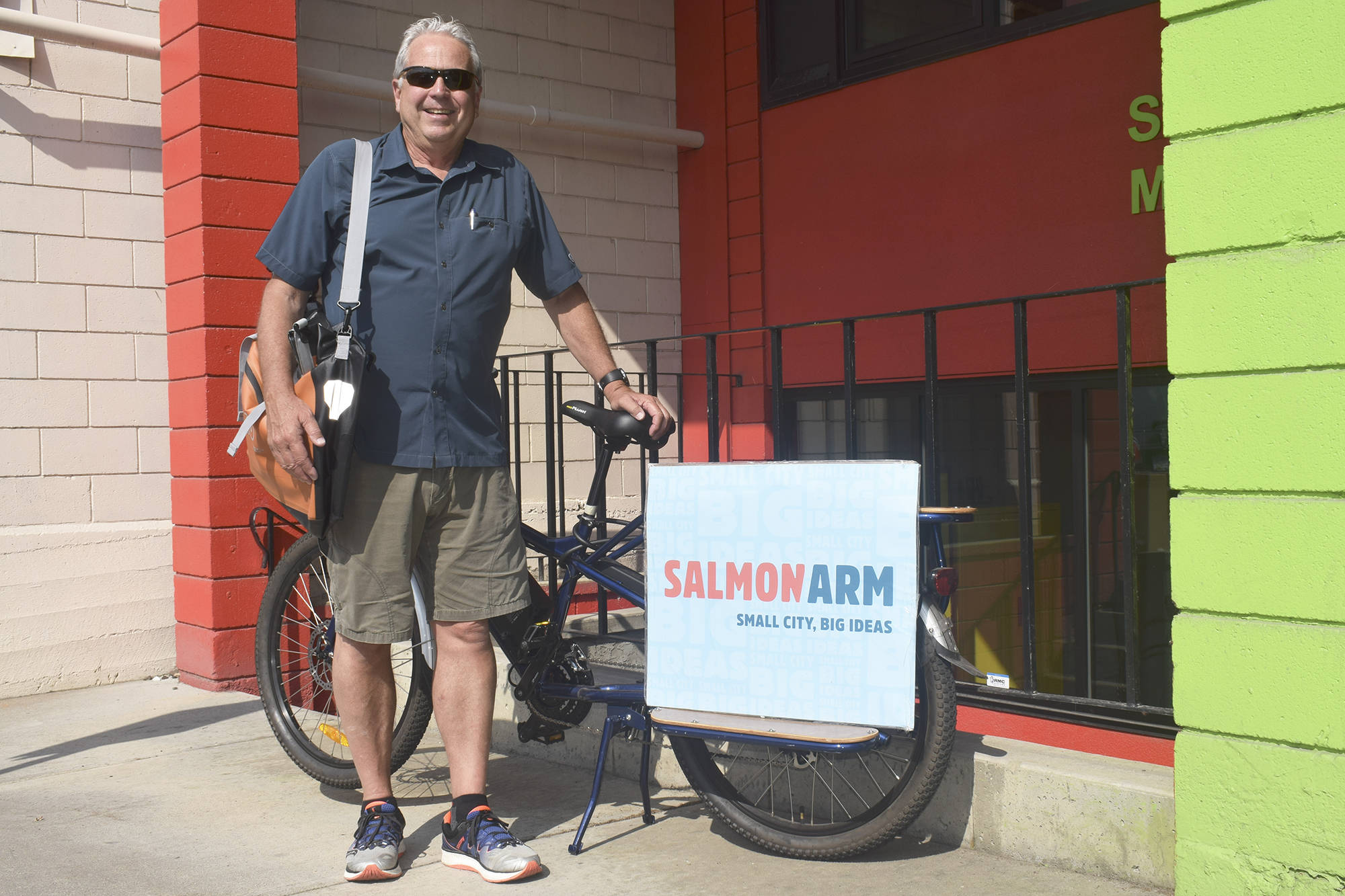 Tim Lavery, in a 2019 photo during smokeless skies, pedals his cargo bike, spreading the word about the citys new brand. (File photo)