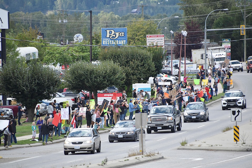 People lined a portion of the Trans-Canada Highway in Salmon Arm during the afternoon of Sept. 1, protesting COVID-19 vaccines, vaccine passports and other issues, prompting honks from some motorists as they drove by. (Martha Wickett - Salmon Arm Observer)