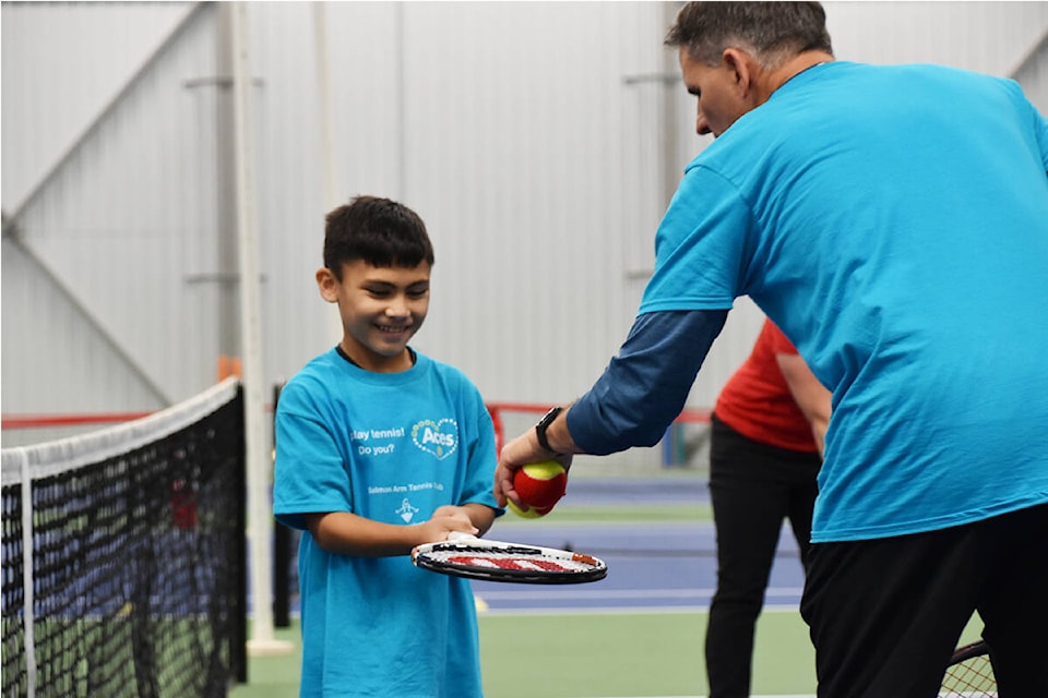 Gabe Iaccino receives instruction from the Salmon Arm Tennis Club’s Winston Pain at the Askew Tennis Centre on Oct. 6, 2021. (Zachary Roman/Salmon Arm Observer)