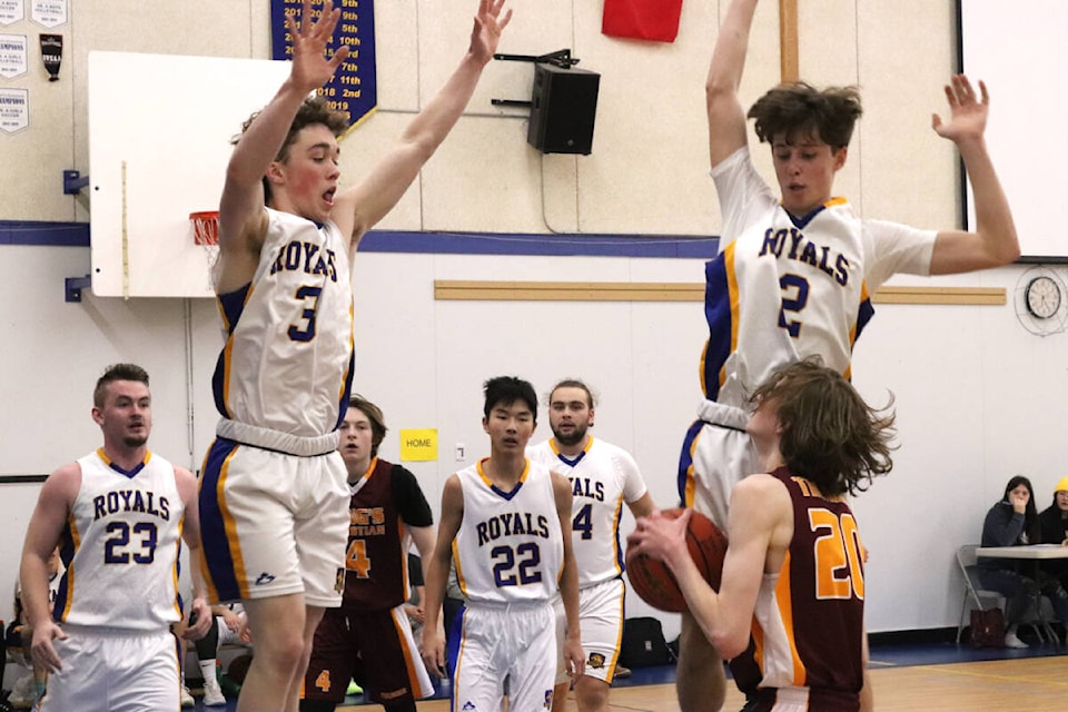 Salmon Arm King’s Christian Thunder forward Joseph Royal (with ball) draws Vernon Christian School Royals defenders Ben Porter (3) and Ben Tishenko off the ground during the North Zone Senior Boys A Basketball Final Friday, Feb. 18, at VCS. (Roger Knox - Morning Star)