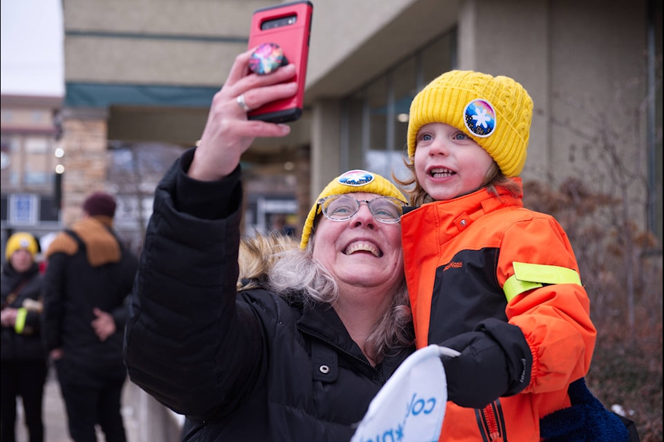 Mary Scheidegger captures a moment with grandson Issac Scheidegger in their new bright yellow toques before heading out with team Sophia Sisters from the downtown SASCU branch for Salmon Arm’s Coldest Night of the Year on Saturday, Feb. 26, 2022. (Lachlan Labere-Salmon Arm Observer)