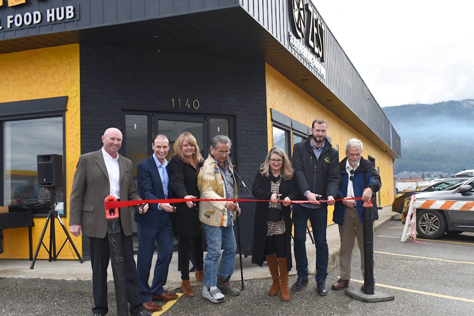 Rob Marshall with Community Futures Shuswap, Salmon Arm Mayor Alan Harrison, Zest facility manager Tracy Edwards, Secwépemc knowledge-keeper Louis Thomas, B.C. Agriculture Minister Lana Popham and SAEDS board members Chad Shipmaker and Bill Laird cut the ribbon for the official grand opening of the Zest Commercial Food Hub on Saturday, March 26, 2022. (Andrea Horton - Salmon Arm Observer)
