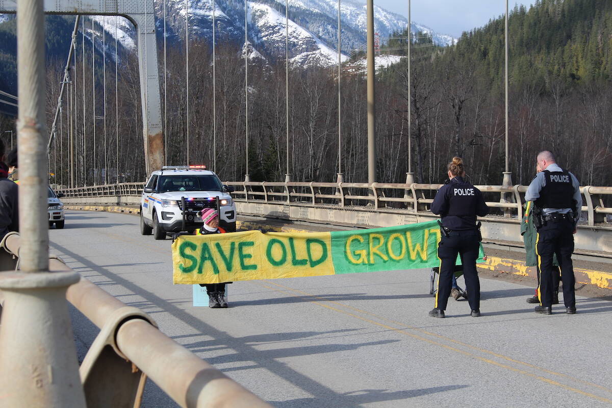 RCMP standing over the blockade on the Columbia River Bridge in Revelstoke on April 9. (Josh Piercey/Revelstoke Review)
