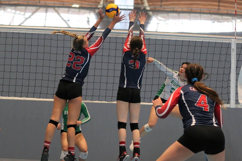 Vernon Firehawks blockers Lauren Hoard (22) and Hailey Duff stuff a would-be kill from a Lower Mainland Ducks opponent with teammate Charlie Calvert (4) providing support during the u17 Girls Volleyball B.C. Club Championships at the Richmond Olympic Oval. (Jenni Duff photo)