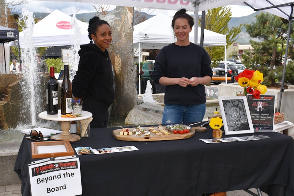 2022 Launch-a-Preneur participants Ana Brideau and Erin Messier promote their Beyond the Board business at the May 7 sneak-peek event at the Downtown Salmon Arm Farmers Market. (Martha Wickett-Salmon Arm Observer)