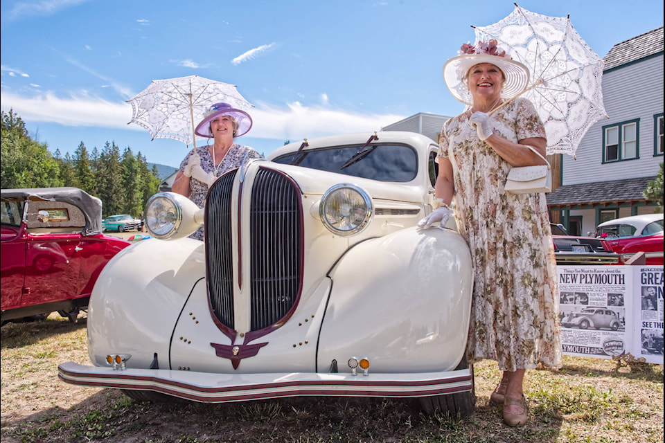 Chris Verburg and Jan McDonnell keep the sun off themselves while showing off the 1938 Plymouth on display at the 21st Annual Car Show at R.J. Haney Heritage Village and Museum on Sunday, Aug. 14, 2022. (Lachlan Labere-Salmon Arm Observer)