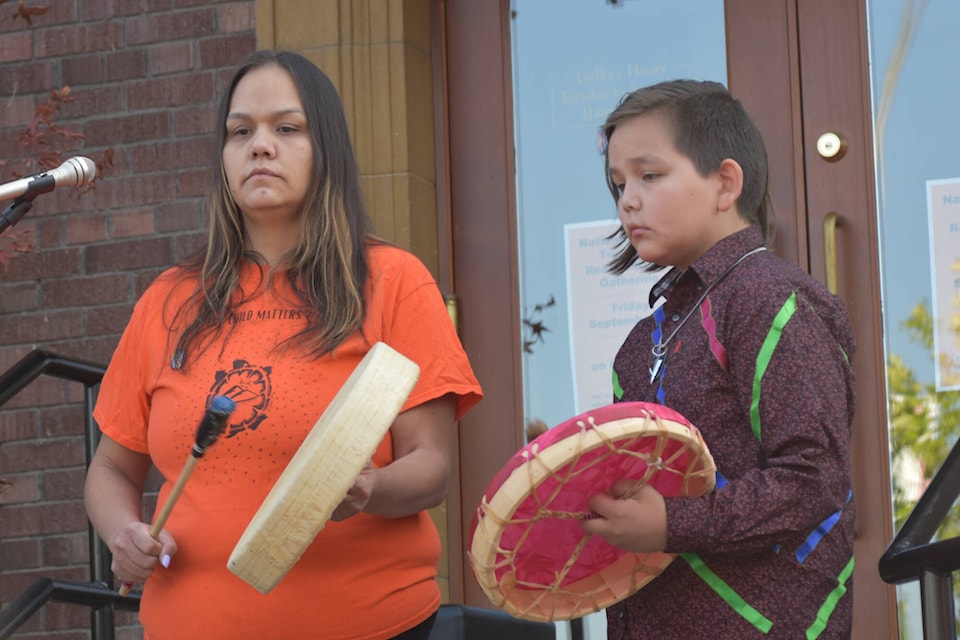 Erica Seymour and her son Logan Christian performed an Honour Song outside the Salmon Arm Arts Centre for all the Indigenous children lost and for the ones still here on Sept. 30, 2022, the National Day for Truth and Reconciliation. (Martha Wickett-Salmon Arm Observer)
