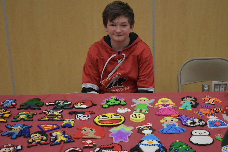 Cortlan Dawydiuk sells his Perler bead Christmas ornaments and decorations at the Christmas Craft and Trade Fair at Eagle River Secondary, Sicamous, Nov. 19 2022. (Rebecca Willson/ Eagle Valley News)