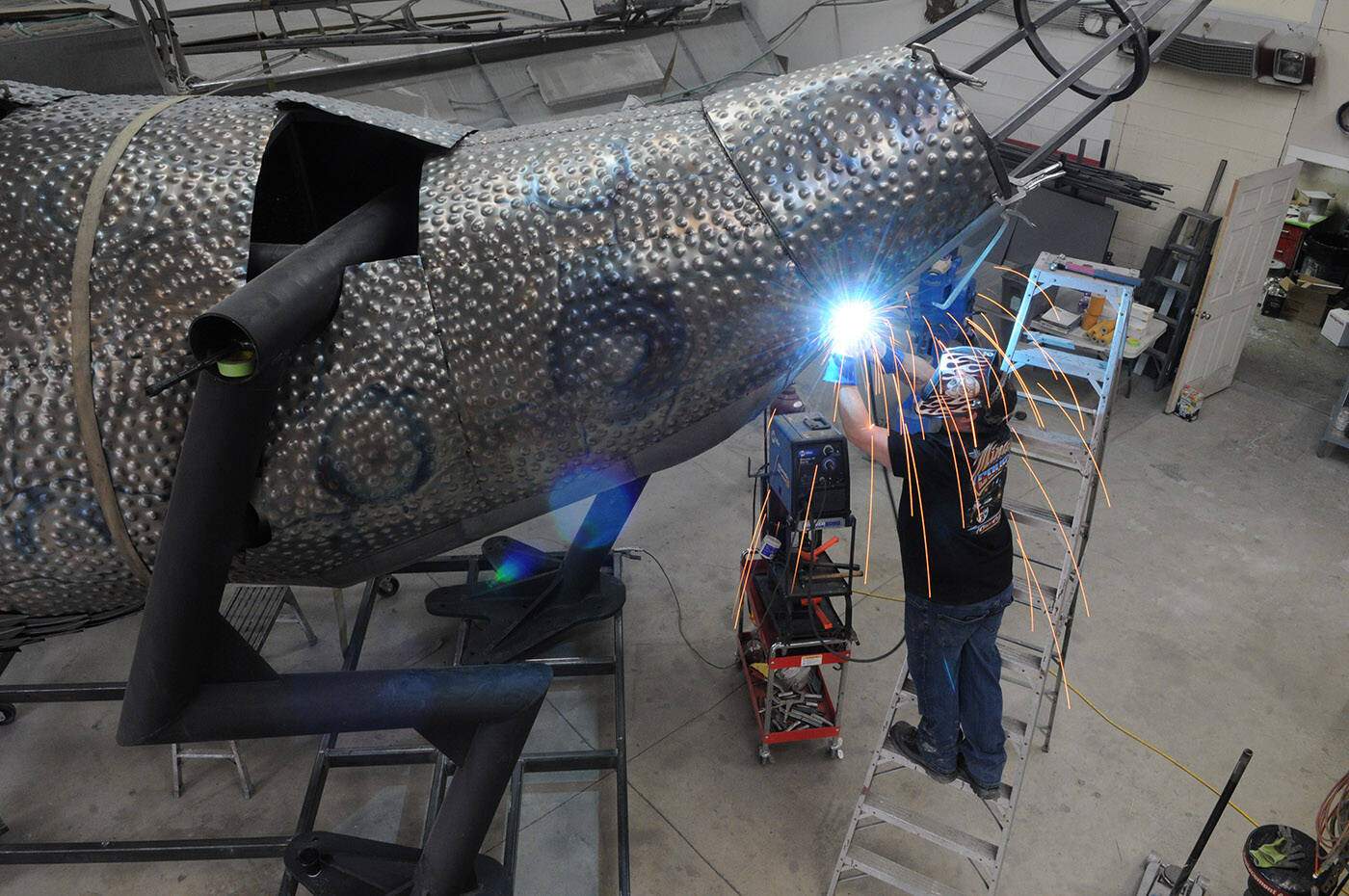 Kevin Stone welds a section of his dragon on March 26, 2021. (Jenna Hauck/ Chilliwack Progress)