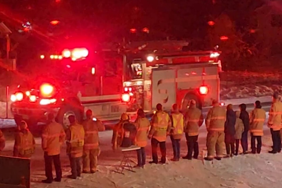 Colleagues, family and friends gather on Silver Star Road outside the BX Swan Lake Fire Department Tuesday, Jan. 31, as an honour guard of emergency vehicles with lights flashing pays respect to late volunteer firefighter David Hentschel. (Contributed)