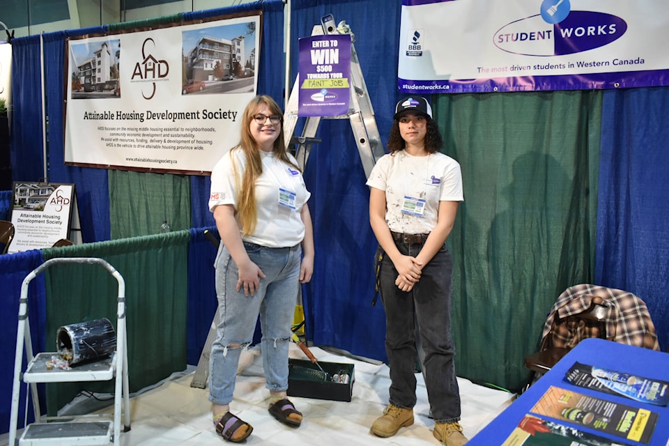 Rebecca Henz and Faith Thurston work for Student Works, which employs students in B.C. to paint houses and and complete other projects. Student Works is on display at the Salmon Arm Spring Home Show Saturday and Sunday, April 29 and 30, at Shaw Centre. (Rebecca Willson/ Salmon Arm Observer)
