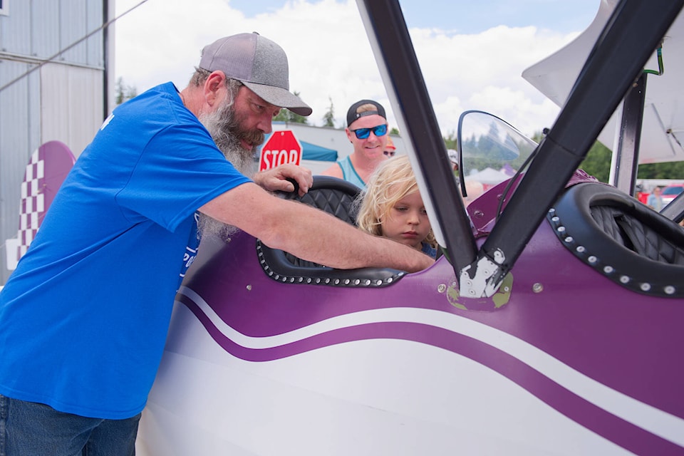 Mike Smith shows Harvey Hansma how the controls work in his two-seater Murphy Renegade Spirit at the Shuswap Regional Airport Open House and Emergency Expo on Sunday, June 25, 2023. (File photo)