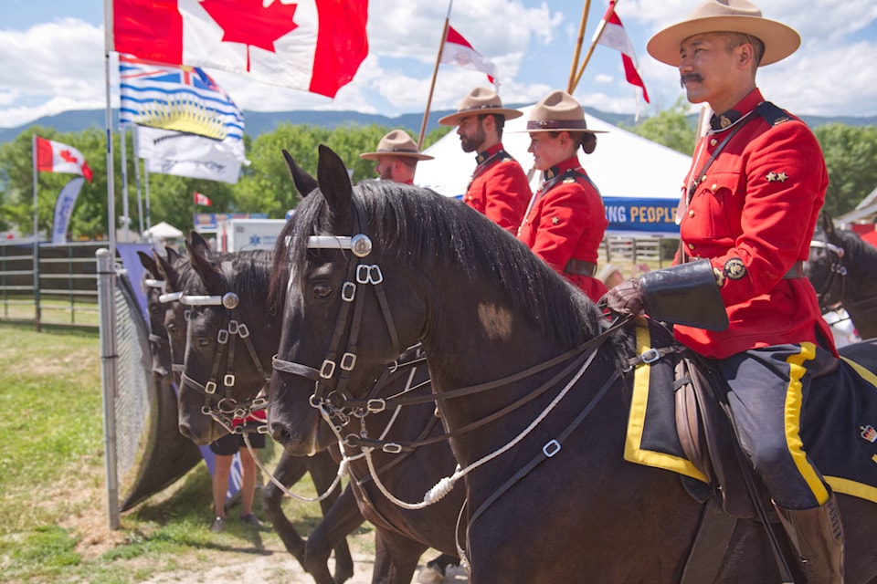 RCMP riders make their way into the Salmon Arm fairgrounds grandstand arena for their sold-out Canada Day Musical Ride performance on July 1, 2023. (Lachlan Labere-Salmon Arm Observer)