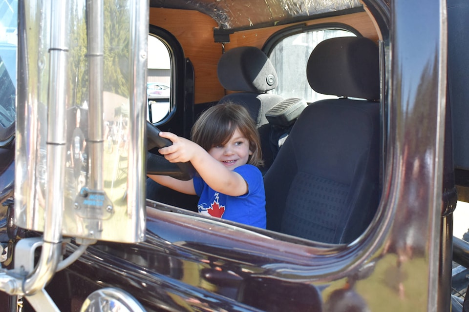 Altin Hincer sits in Jeff Greenlaw’s 1939 International D-15 truck at the Moose Mouse Days car show Saturday, July 29, 2023. (Rebecca Willson-Eagle Valley News)
