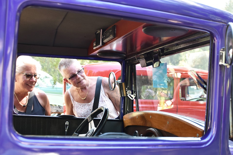 Two car-loving ladies check out the interior of a purple classic car at the R.J. Haney Museum’s car show Sunday, Aug. 13, 2023. (Rebecca Willson-Salmon Arm Observer)