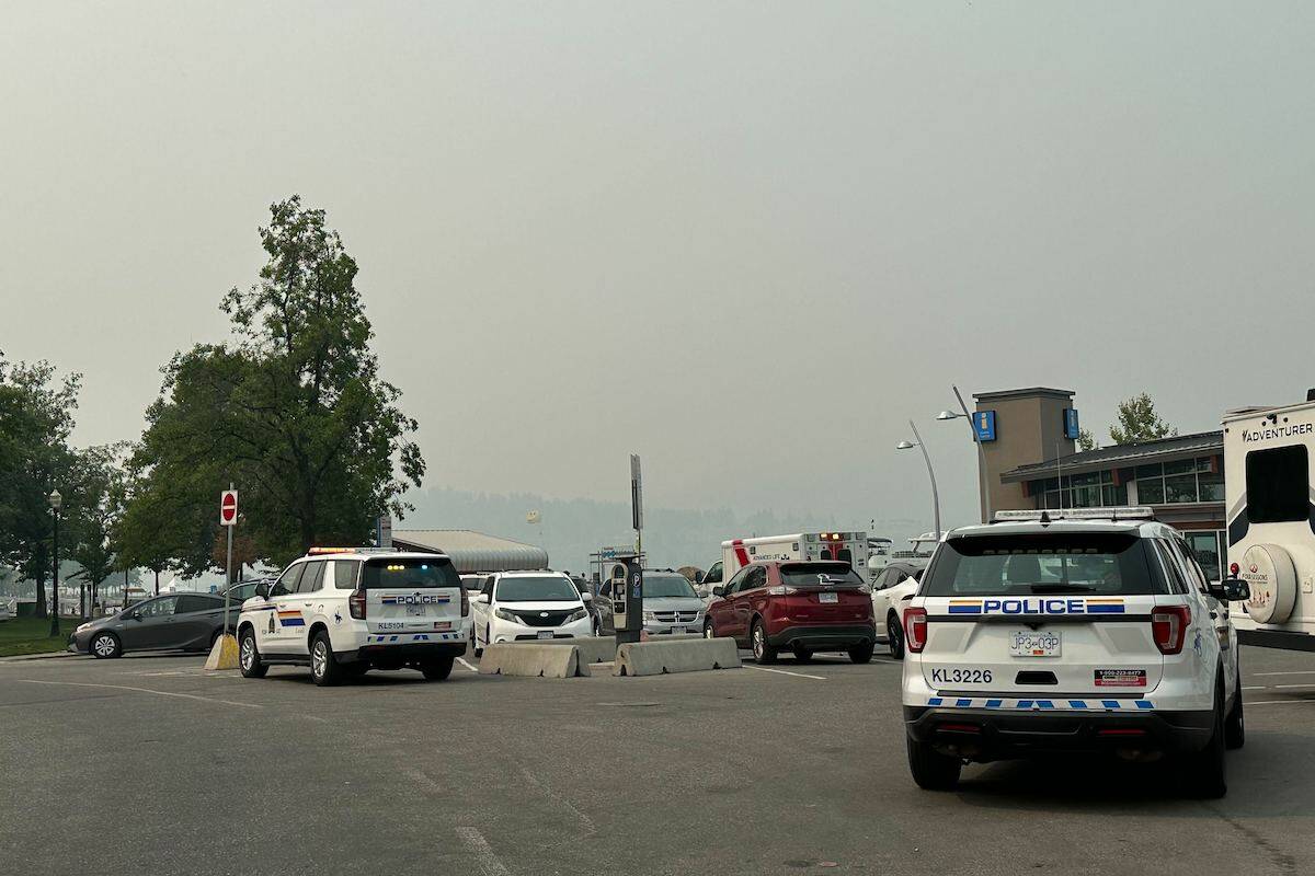 RCMP and BC Ambulance wait at Kelownas Visitors Centre. (Jordy Cunningham/ Capital News)