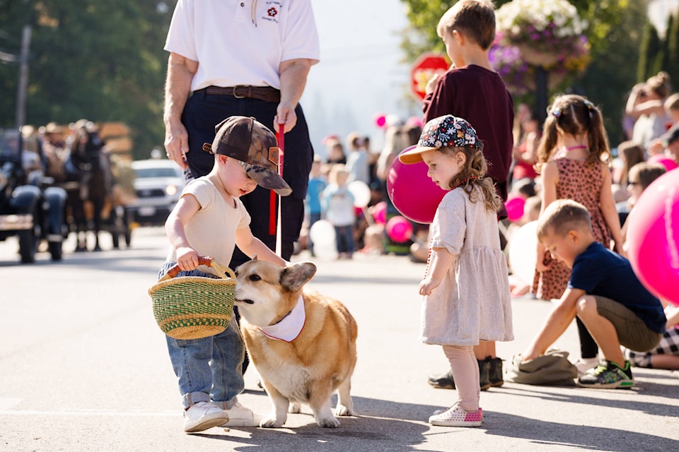 Ballack Campbell and Ellie Gunn receive visit and a sniff from a St. John Ambulance therapy dog during the Salmon Arm Fair Parade held Saturday morning, Sept. 9, 2023. (Kayleigh Seibel Photography)
