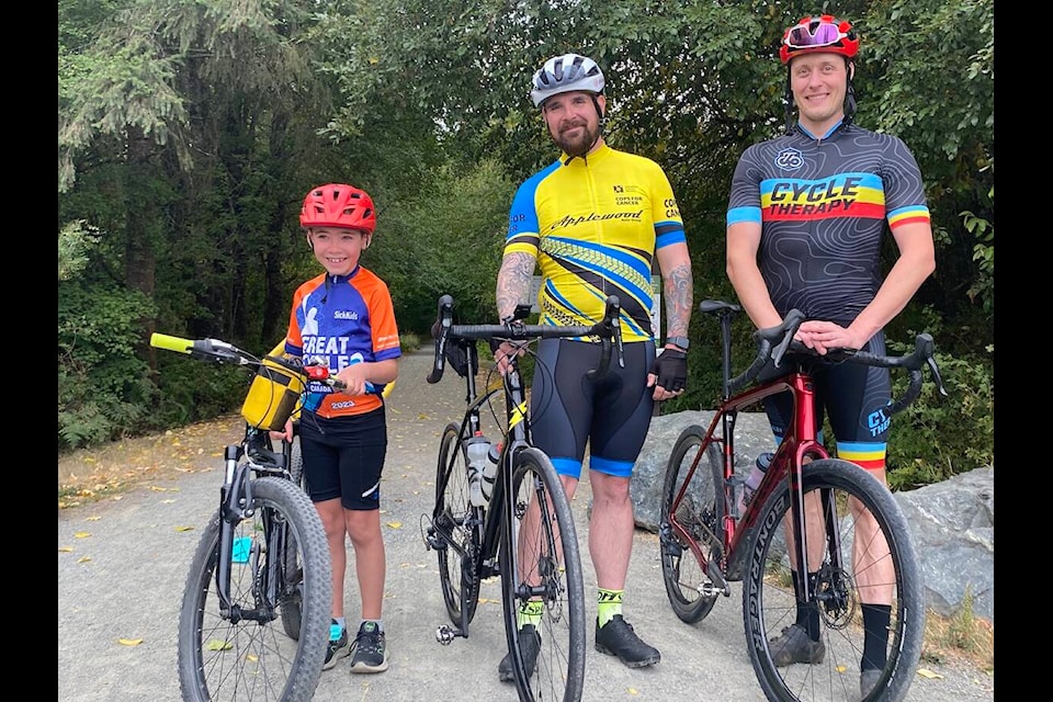 Eight-year-old Mason Scargall (left) poses with RCMP officer Wes Richens and supporter Cycle Therapy owner Matt Grossnicken before embarking on a 50 km trek to Lake Cowichan and back which took three hours to complete. Scargall made it his mission to pedal 300 km to raise money and awareness for cancer this year. Mason is donating his proceeds of $400 from his summer farm stand to support Richens goal of $30,000 for this year’s Tour de Rock which will be coming to Lake Cowichan on Oct. 3 (Chadd Cawson/Gazette) 