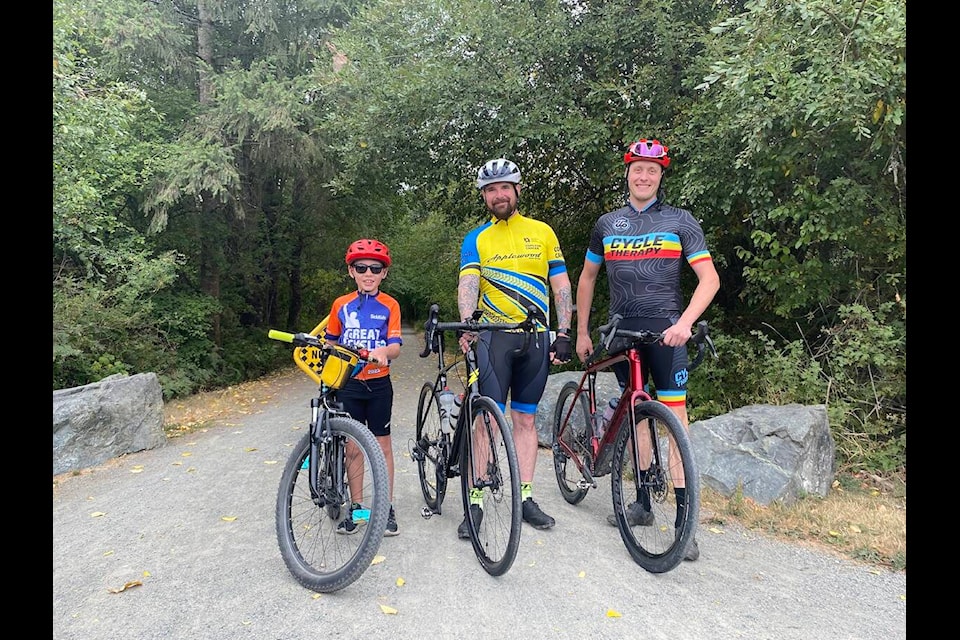 Eight-year-old Mason Scargall (left) poses with RCMP officer Wes Richens and supporter Cycle Therapy owner Matt Grossnicken before embarking on a 50 km trek to Lake Cowichan and back which took three hours to complete. Scargall made it his mission to pedal 300 km to raise money and awareness for cancer this year. Mason is donating his proceeds of $400 from his summer farm stand to support Richens goal of $30,000 for this year’s Tour de Rock which will be coming to Lake Cowichan on Oct. 3 (Chadd Cawson/Gazette) 