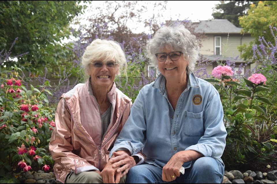 Judy Underwood (left) and Judy Smith (right) love working on the lower garden at the condo building at 2447 Henry Ave. (Brendan Mayer/News Staff). 