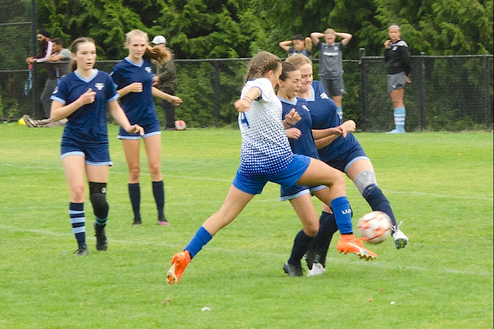 Langley United U15 Division 1 girls (in white), seen here during their fourth and determining Premier International 2023 Cup match against North Shore on Sept. 4, managed three shutouts on the way to winning their division. (Special to Langley Advance Times) 