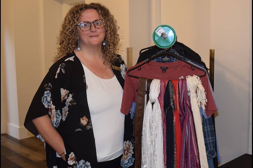 Mustard Seed Street Church and Food Bank director of operations Treska Watson stands by the clothing bank in the organization’s revamped hospitality space. (Brendan Mayer/News Staff) 