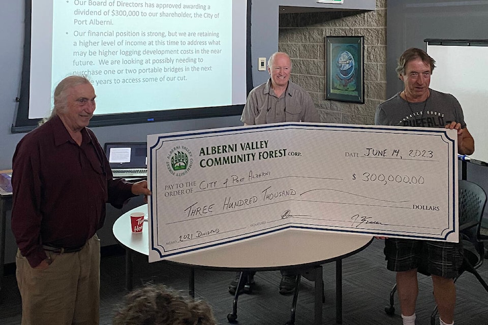 Retiring Alberni Valley Community Forest board member Gary Swann, left, and Chris Duncan present Port Alberni City Councillor John Douglas, right, with a cheque for $300,000 from 2021 dividends. (PHOTO COURTESY CHRIS LAW) 