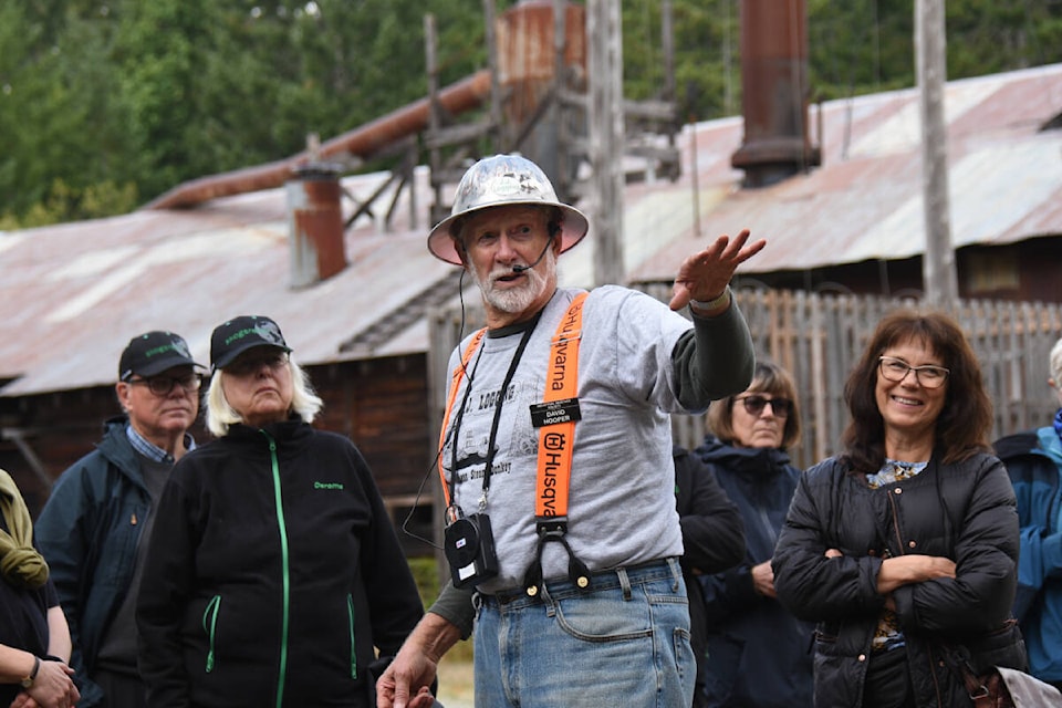Western Vancouver Island Industrial Heritage Society volunteer David Hooper explains the workings of the blacksmith’s shop at McLean Mill National Historic Site during a tour with loggers and foresters from Sweden on Aug. 31, 2023. (SUSAN QUINN/ Alberni Valley News) 