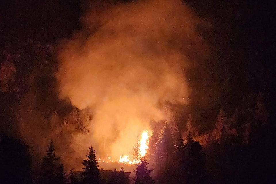 A spot fire on Squilax-Anglemont Road at Butters Road broke out again in the early hours of Thursday, Sept. 14, threatening a number of structures including a new home under construction in the foreground. (Contributed) 