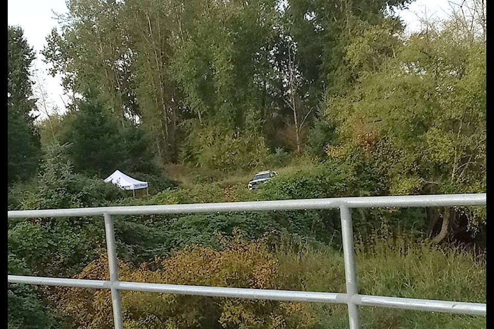 Police taped off trails after a body was found at the scene of a fire in a 91ԭ City’s Nicomekl park near 208 and Fraser on Friday night, Sept. 22. (Mary Parnell/Special to 91ԭ Advance Times) 