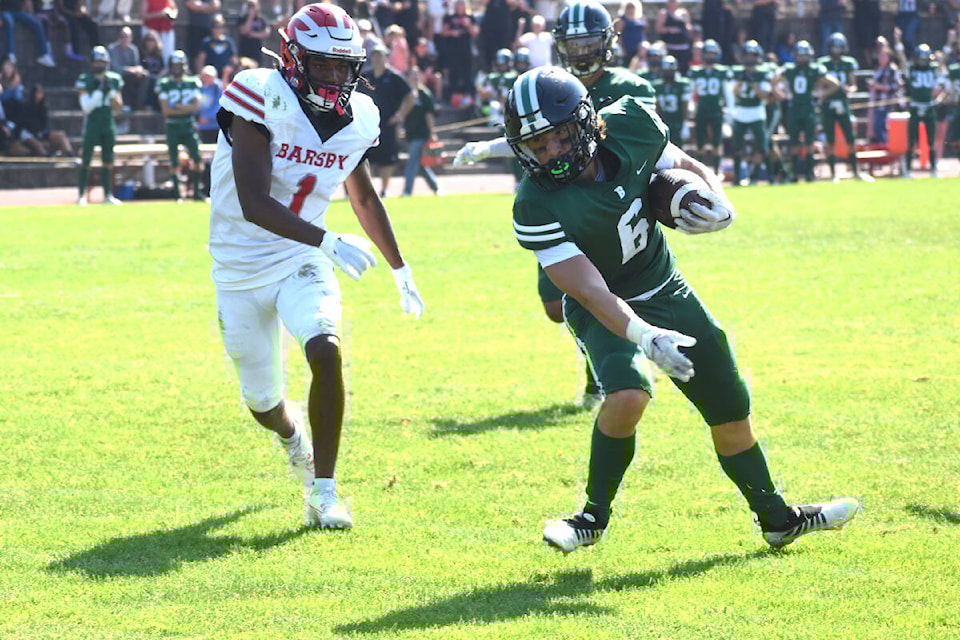 Bateman running back Jackson Kliewer avoids a Barsby defender on Friday (Sept. 22). (Ben Lypka/Abbotsford News) 