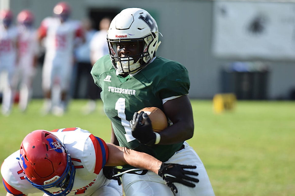 Eddie Aimiose runs the ball for the Lord Tweedsmuir Panthers in a game Sept. 22 against Centennial in Cloverdale. Aimiose plays both sides of the ball, fullback and linebacker, and he ran in two TDs in the game. (Photo submitted: Marcus Tam) 