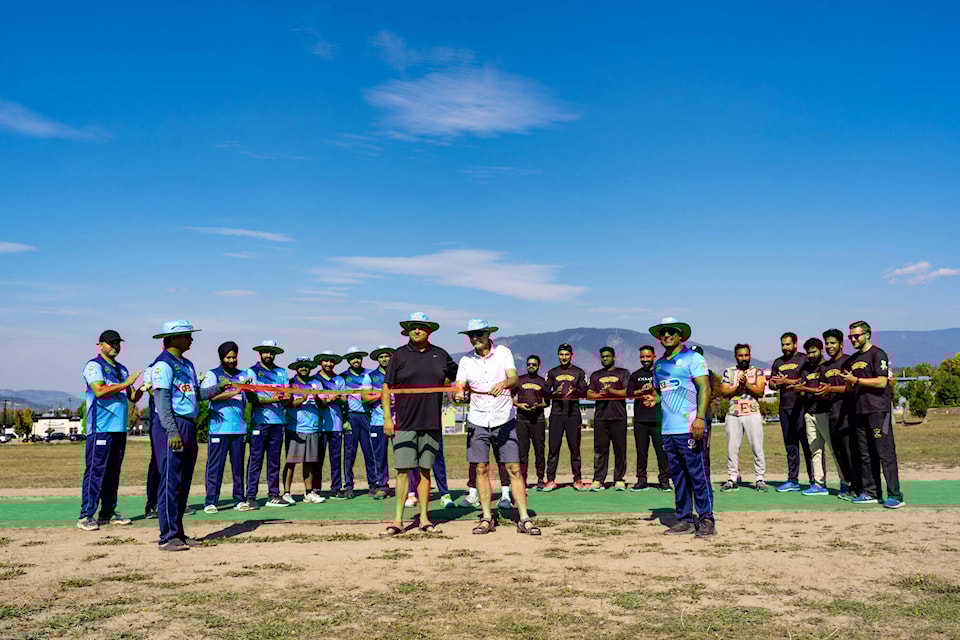 Salmon Arm Mayor Alan Harrison is accompanied by the Salmon Arm and Revelstoke cricket clubs during a ribbon-cutting ceremony for the city’s new cricket pitch on Sunday, Sept. 17, 2023. (Selina Metcalfe/Ihana Images photo) 