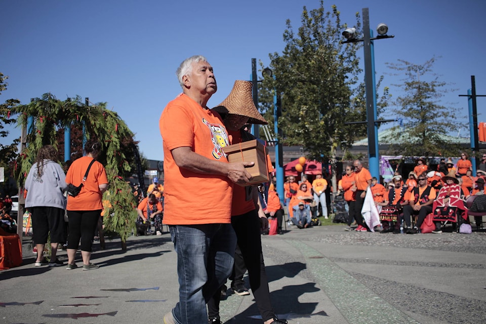 Elder and residential school survivor James Quatell is honoured with a bent wood cedar box made by Campbell River artist in residence Shawn Decaire. Photo by Marc Kitteringham/Campbell River Mirror 