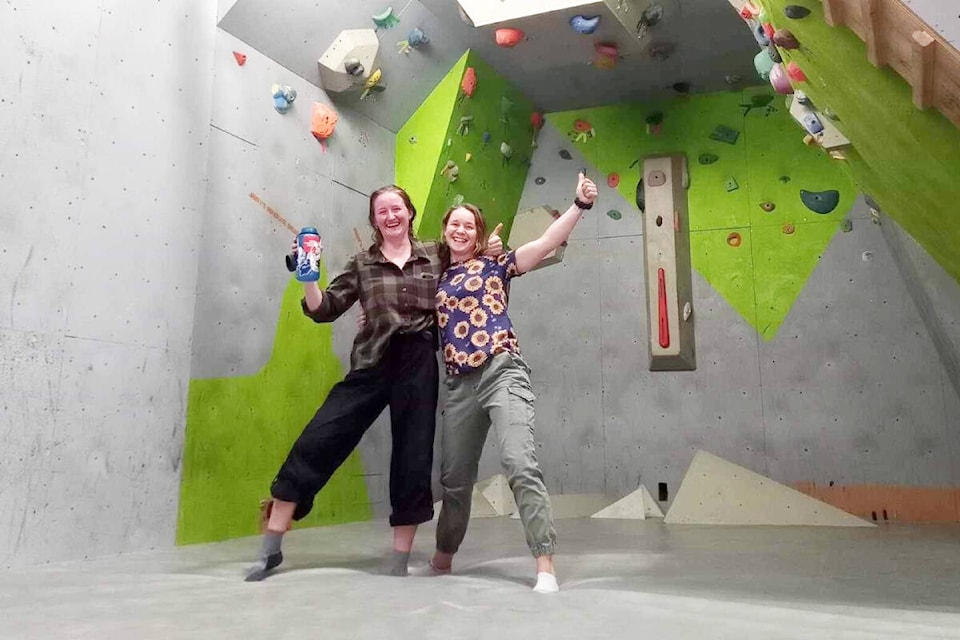 Mae Frank, left, and Kelsey Miller of the Williams Lake Climbing Association working on resetting the bouldering wall for the Bouldering Club, starting back up Oct. 3, 2023 at Williams Lake Secondary School - WL campus. (Photo submitted) 