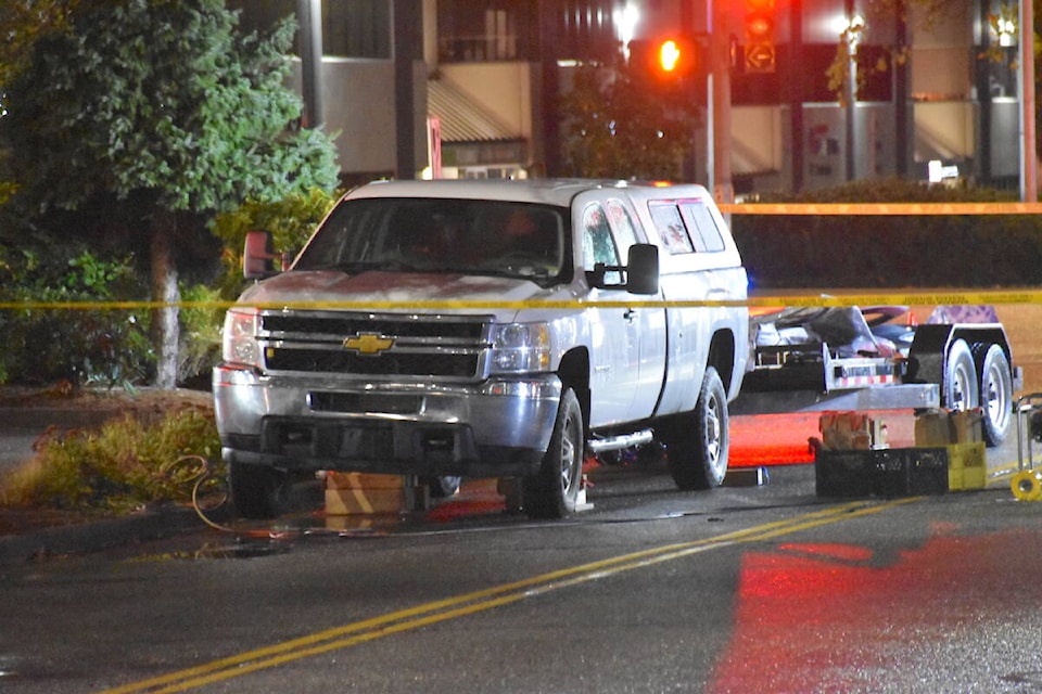  A 21-year-old woman from Surrey was taken to hospital after she became trapped underneath a pickup truck at the intersection of 202nd Street and 64th Avenue in Langley on Monday night, Oct. 2. (Curtis Kreklau, South Fraser News Services/Special to Langley Advance Times) 